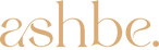 The logo for 'ashbe.' features the brand name in a large, elegant tan serif font with a dot, and the tagline 'WHERE CUSTOM MEETS QUALITY' in smaller tan uppercase letters below, all set against a solid white background.